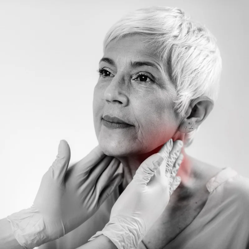 Black and white image of mature lady having jaw examined
