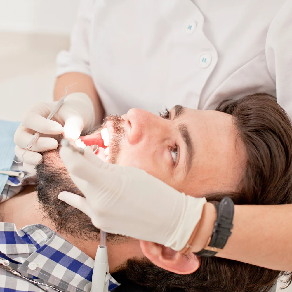 Man in dentist's chair receiving cosmetic dental treatment