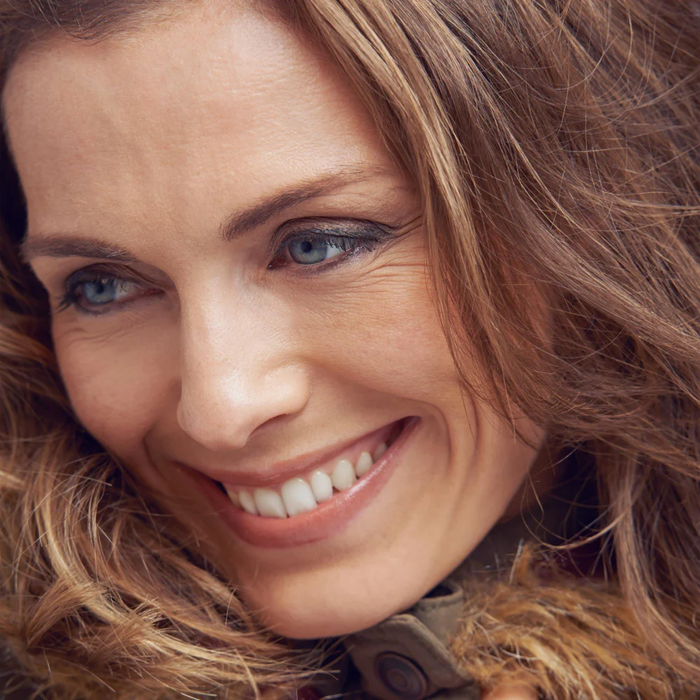 Mature smiling woman facing left