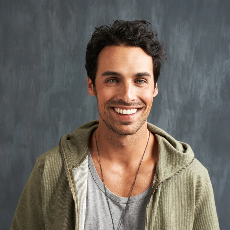 Young man smiling after a smile makeover